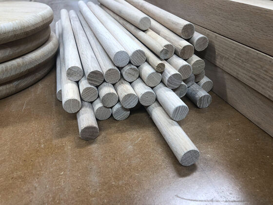 Stacked oak dowels on a workbench