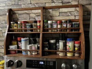 Wooden spice rack mounted above a stove