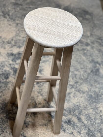 Finished oak bar stool, studio-style photograph