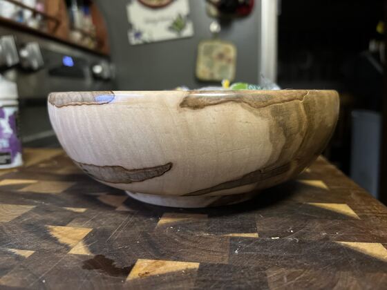 Side profile of a turned spalted maple bowl