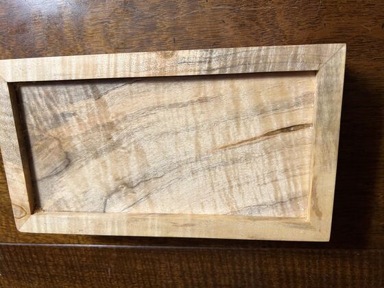 Curly maple valet tray on a table