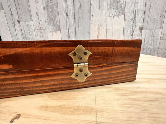 Close-up of a brass hinge on a wooden box
