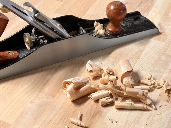 Hand plane resting in curled wood shavings
